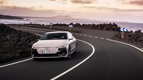 Audi A6 e-tron Sportback: front three quarter driving, ocean in background, beige paint