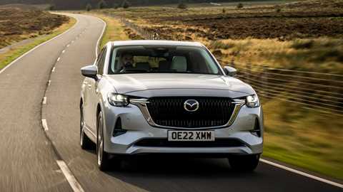 Mazda CX-60 front three quarter tracking shot, British B-road, silver car