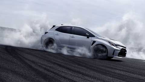 Toyota GR Corolla smoking all four tyres, side view