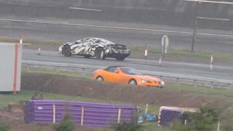 A typically McLaren bright Papaya Orange SLR passes the new McLaren MP4-12C