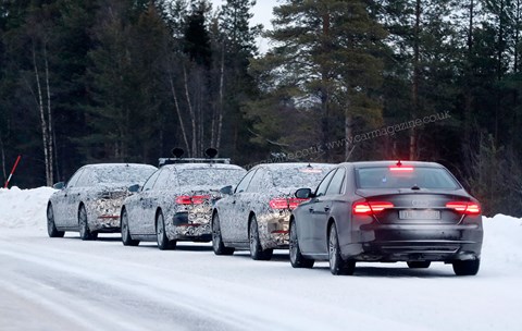 A procession of Audi A8s in winter testing in Sweden
