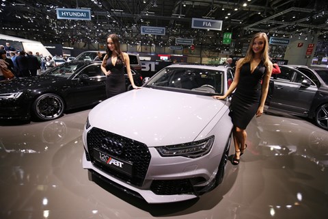 Girls adorn a tuner car at the Geneva motor show